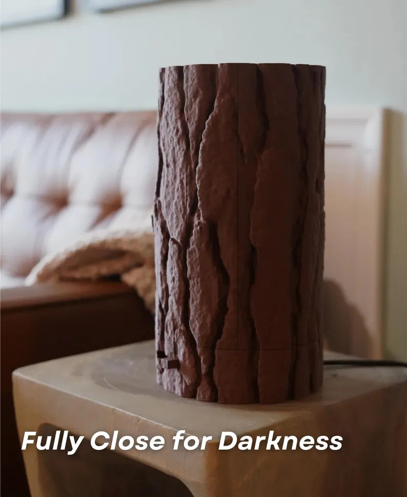 Log Table Lamp in brown on a wooden table, showcasing its unique design and natural wood-like texture by Loffa Design. Loffadesign